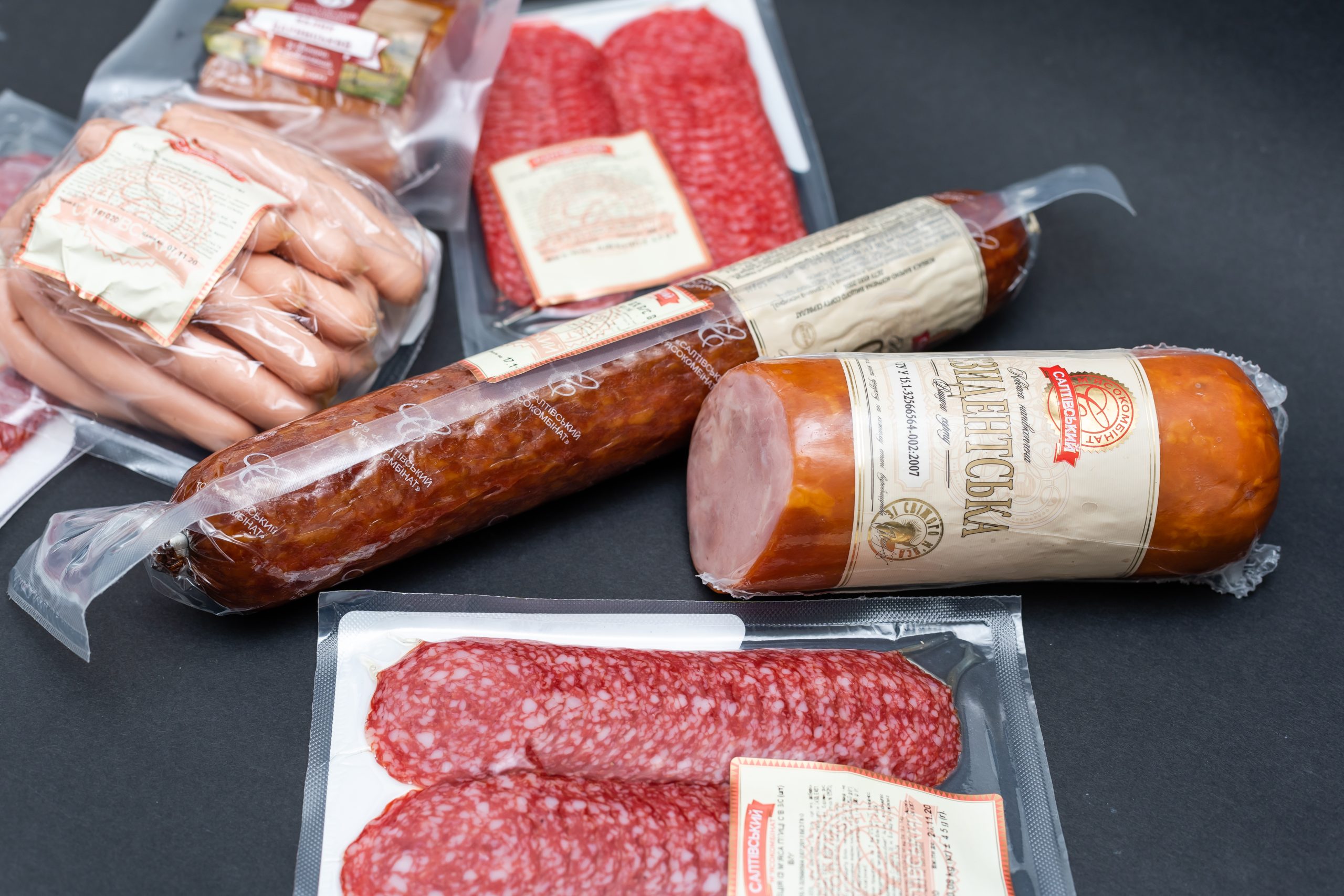 sausages in a plastic package on dark background